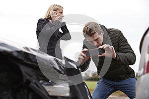 Drivers Taking Photo Of Car Accident On Mobile Phones