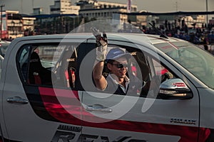 Drivers waving hand to the audience after show