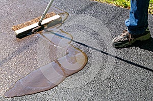 Driveway maintenance, spreading sealant