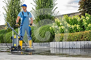 Driveway Pressure Washing Performed by Worker