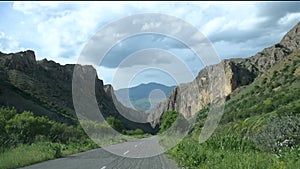 Driving through Armenian landscape in spring. Point of view road to Noravank monastery