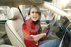 Driving around city. Young attractive woman driving a car