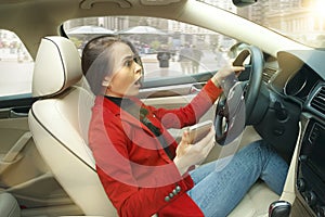 Driving around city. Young attractive woman driving a car