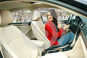 Driving around city. Young attractive woman driving a car