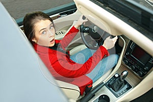 Driving around city. Young attractive woman driving a car