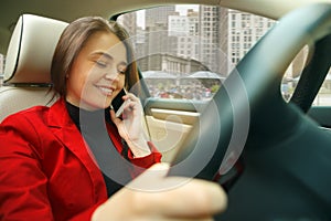 Driving around city. Young attractive woman driving a car