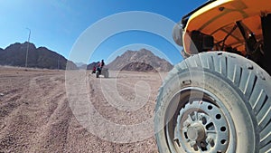 Driving of the ATV in the Desert of Egypt. Extreme view of the wheel off-road vehicle