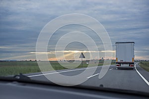 Driving behind  refrigerator truck or chiller lorry at sunset