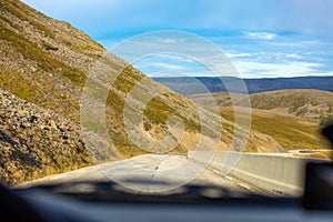 Driving a car along a winding mountain road