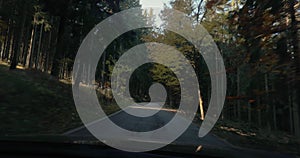 Driving a car through autumn mountain landscape