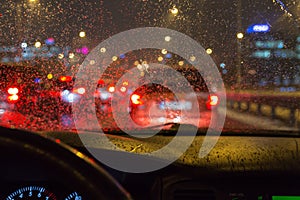 Driving a car in a bad weather, in traffic jam