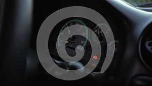 Driving a car with check engine light on. Dashboard closeup