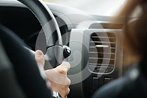 Driving a car - close-up on steering wheel, selective focus