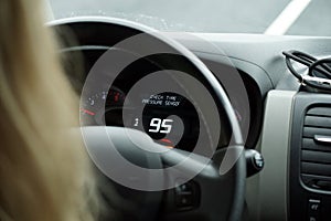 Driving a car - close-up on steering wheel and speedometer