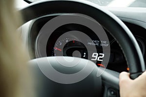 Driving a car - close-up on steering wheel and speedometer