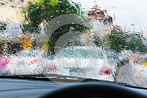 Driving car on evening time with raindrop on glass