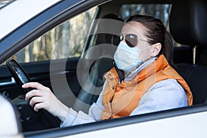 Driving car with face mask and sunglasses