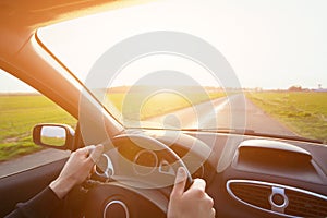 Driving car, hands of driver on steering wheel