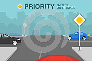 Driving a car. Main or priority road sign rule. Cars on crossroad.