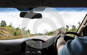 Man driving car along highway