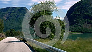 Driving in a car in mountains of Norway with point of view through front windshield, with the