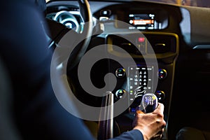 Driving a car at night - pretty, young woman driving her car