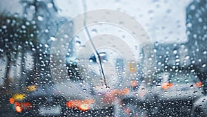 Driving car on road in the rain with raindrop over the wind shield