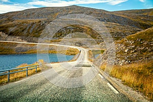 Driving a car on road in tundra. Nature of Norway