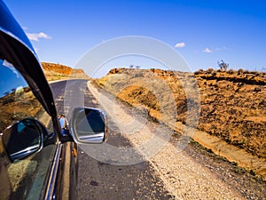 Driving a car on scenic Route Nationale 7 RN7 through the savannah of Madagascar highlands