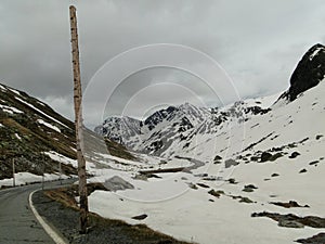Driving a car thru a mountain pass in the Switzerland in Gray cloudy winter day