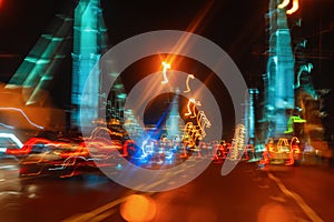 Driving on the city bridge at night, moving cars with urban street illumination, motion blur. Concept of modern