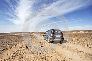 Driving on dirt road through Sahara desert, Morocco