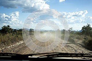 Driving on a dirt road to deliver parcels in rural areas of Brazil.