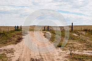 Driving on a dirt road under a cloudy sky