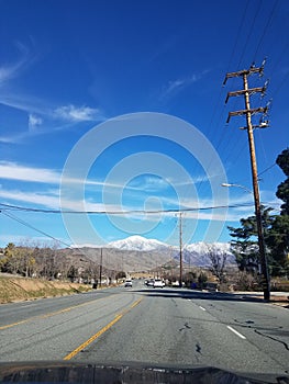Driving down road with mountain in view