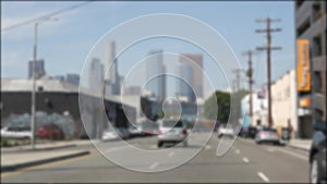 Driving on downtown streets of Los Angeles, California USA. Defocused view from car thru glass windshield on driveway