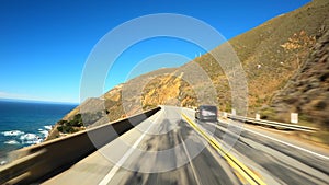 Driving on the edge in scenic Big Sur California Cabrillo Highway 1 coast road, pov back south