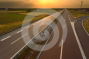Driving on an empty motorway at sunset