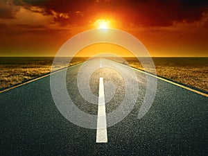 Driving on an empty road at sunset