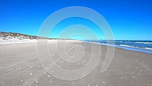 Driving fast Texas beach sand seashells waves and dunes POV 4K G22