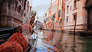 Driving with the Gondola through a small Venezian canal.