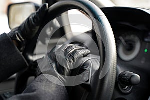 Driving hands in leather gloves