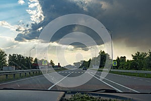 Driving on a highway with dramatic clouds