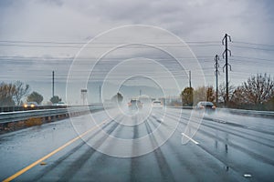 Driving on the highway on a rainy day with low visibility; wet pavement; south San Francisco bay area