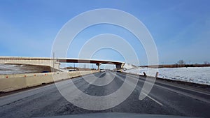 Driving Highway With Roadside Snow in Day. Driver Point of View POV of Interstate or Motorway or Expressway or Freeway