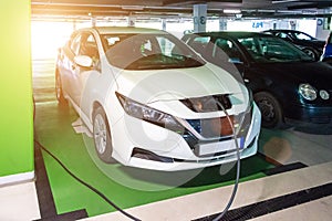 Driving hybrid. Hybrid vehicle - green technology of future. Electric car charge battery on eco energy charger station. Power