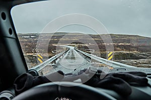 Driving in Iceland, wet road, single-lane bridge