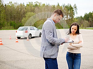Driving instructor and woman student photo