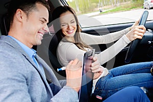 Driving instructor and woman student photo