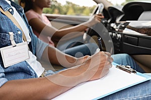 Driving Instructor Writing Down Results Of Exam, driving school concept